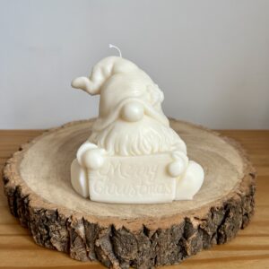 Gonk holding Merry Christmas Sign Candle